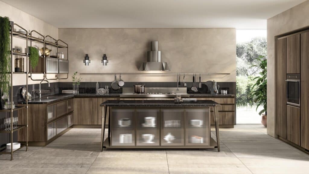Modern kitchen interior with wood cabinets, dark countertops, and stainless steel appliances. Large island with glass-front cabinets in the center.