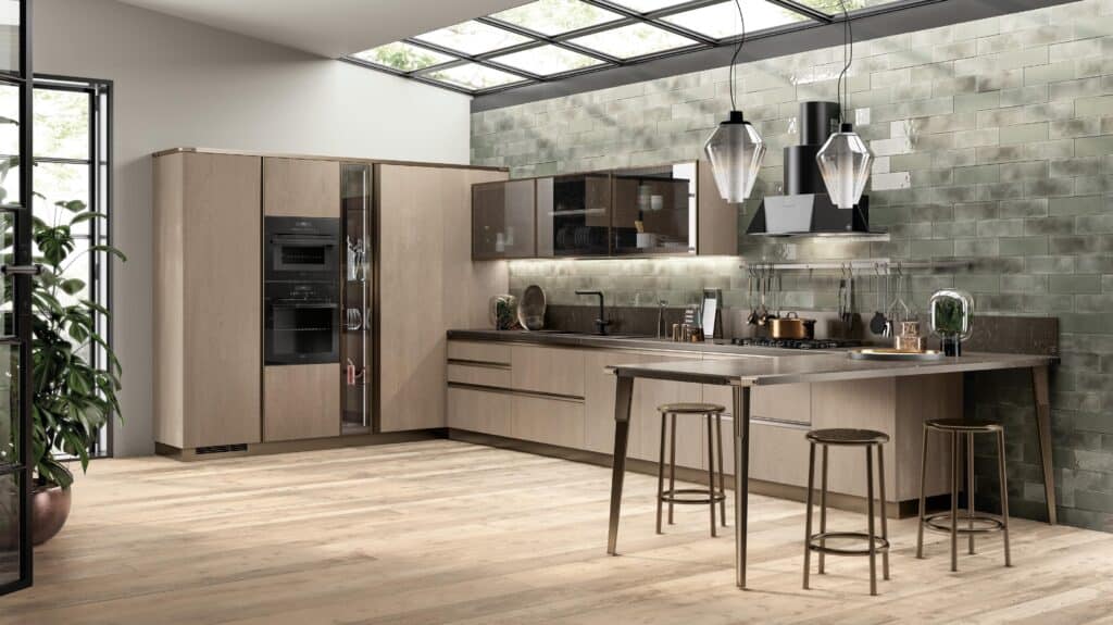 Modern kitchen with glass ceiling, light wood cabinetry, green-tiled walls, and two pendant lights over a bar with stools.