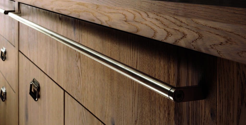 Modern metal handle on a light wood drawer.