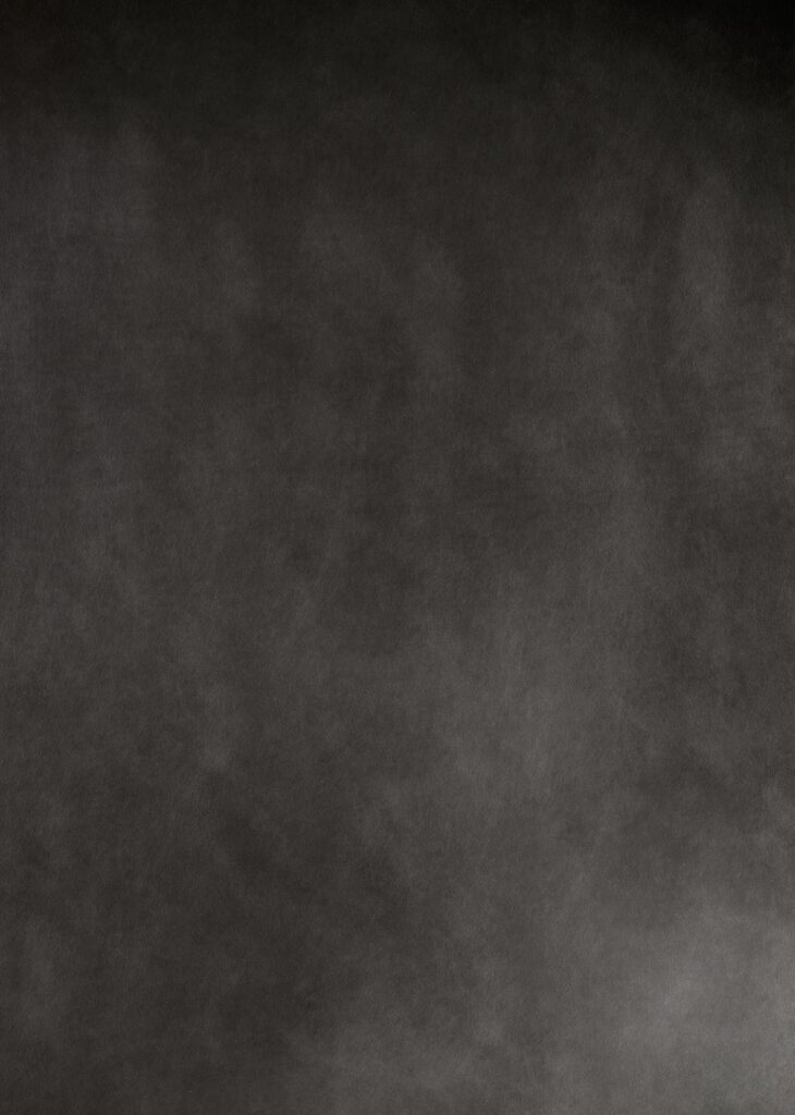 Dark textured background with a subtle cloudy pattern.