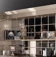 Elegant mantel with decorative items including candlesticks, books, and sculptures, reflected in a mirrored wall.