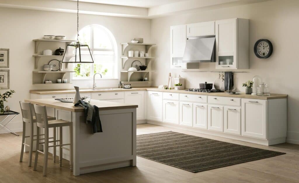 Modern kitchen with white cabinets, wooden countertops, a central island with bar stools, open shelving, and a large window.
