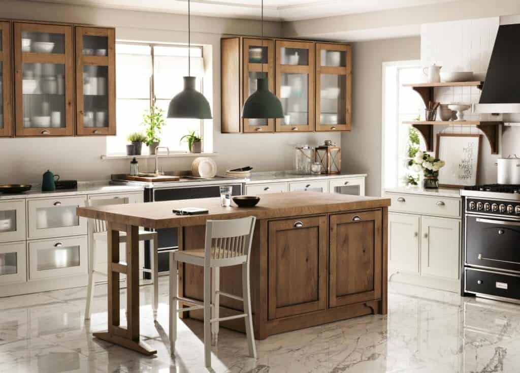 Modern kitchen with wood and white cabinetry, marble flooring, a wooden island, and hanging black lamps.