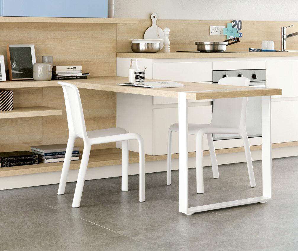 Modern kitchen with a light wooden table, two white chairs, and minimalist decor.