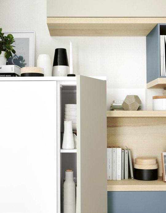 Modern kitchen shelf with white cabinets, wooden accents, and minimalist decor, including vases, books, and geometric objects.