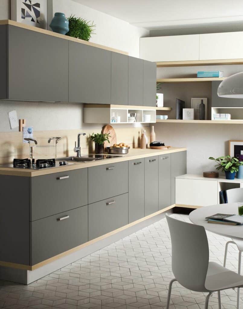 Modern kitchen with sleek gray cabinets, wood accents, and minimalist decor.