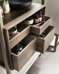 Wooden shelves with open drawers holding various bottles and containers.