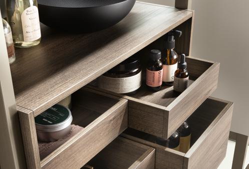 Wooden shelves and open drawers filled with various bottles and containers.