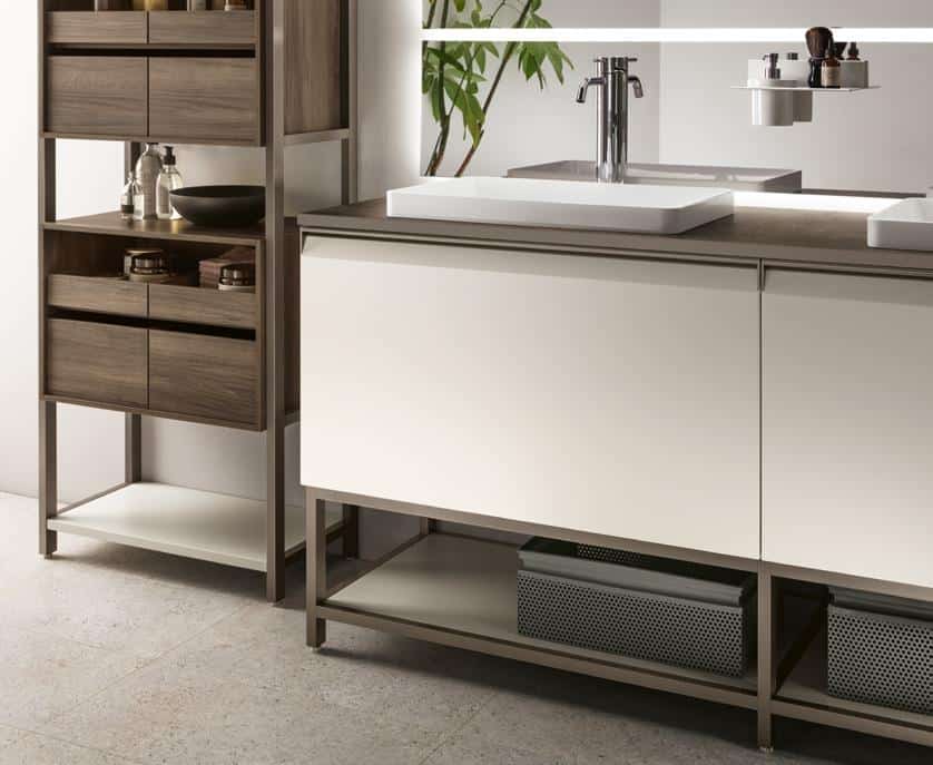Modern bathroom with a white vanity, sleek faucet, wooden shelving, and decorative items.