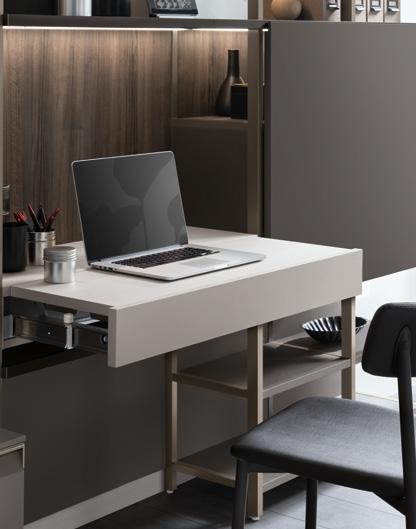 Modern home office setup with a laptop on a floating desk, surrounded by shelves and a chair.