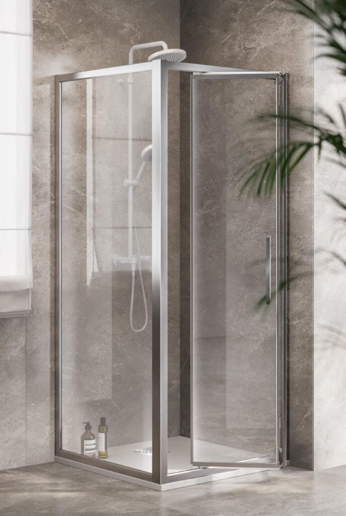 A modern glass shower enclosure with a metal frame and door, set against a stone-tiled bathroom wall.