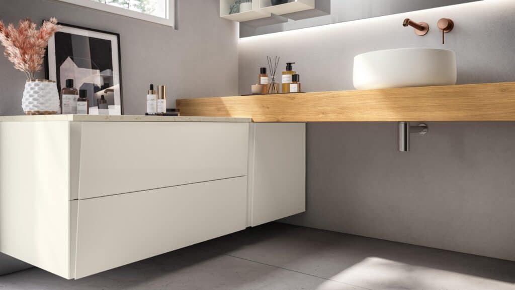 Modern bathroom interior with a floating vanity, wooden countertop, round white vessel sink, wall-mounted faucet, and decorative items on the left side.