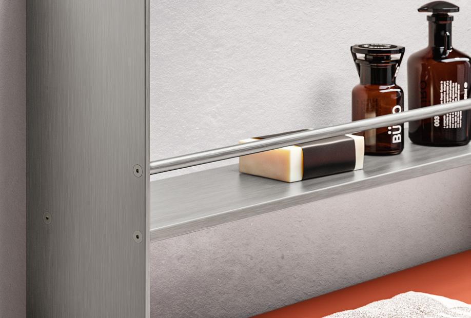 Metal shelf with a soap bar and two brown bottles.