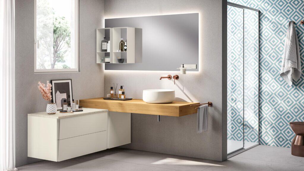 Modern bathroom interior with a wooden floating vanity, circular basin sink, backlit mirror, geometric patterned wall tiles, and wall-mounted faucet.