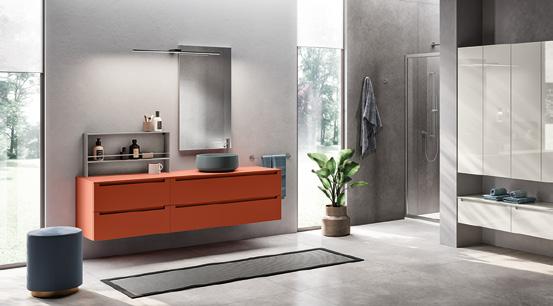 Modern bathroom with an orange vanity, round basin, large mirror, shower enclosure, and a potted plant.