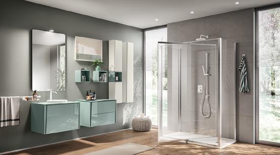 Modern bathroom with a glass shower, gray and teal cabinets, large mirrors, and a towel rack.