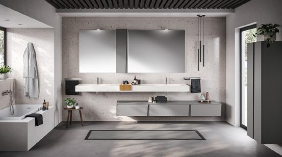Modern bathroom with a minimalist design, featuring a double vanity with large mirrors, a bathtub, gray cabinetry, and a hanging robe.