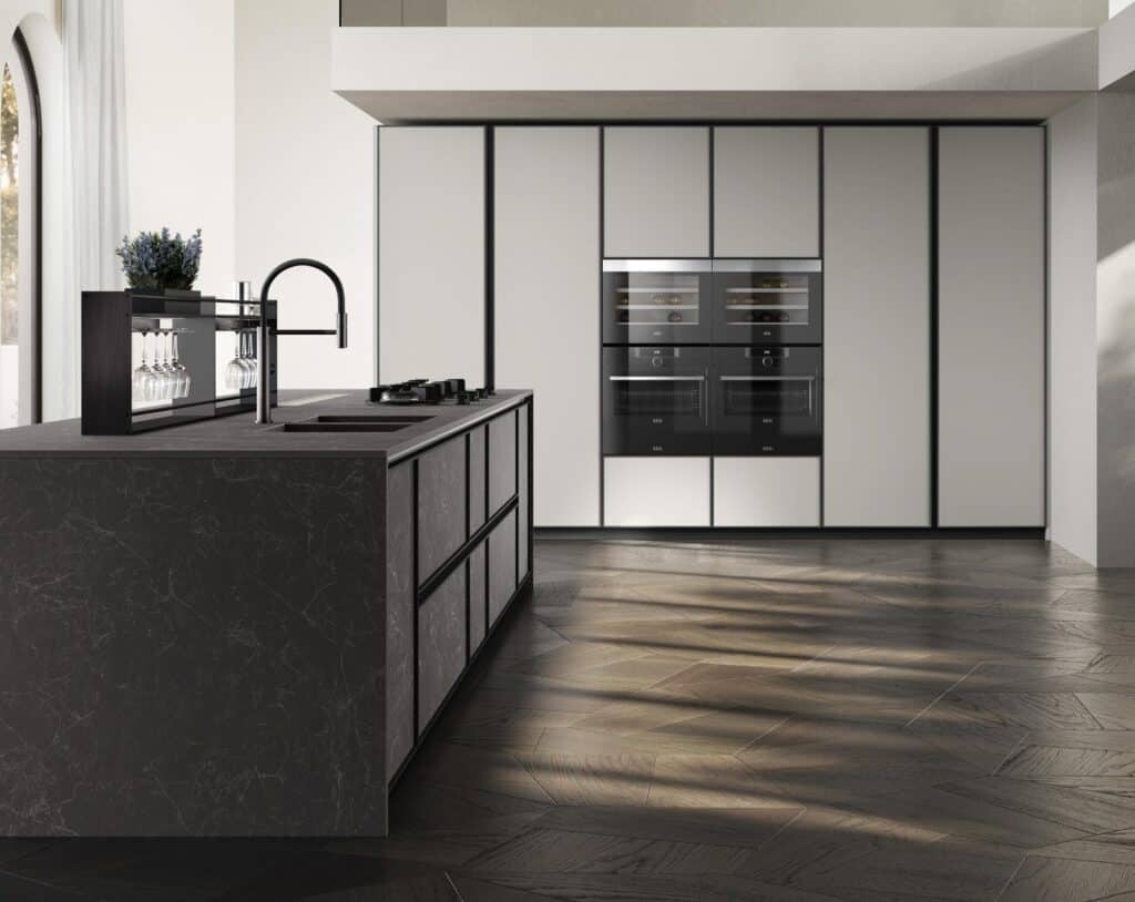 Modern kitchen with a dark marble island, built-in ovens, and sleek cabinetry.