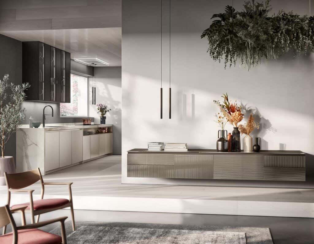 Modern kitchen interior with minimalist design, featuring light cabinetry, dark accents, and plants. A countertop with a black faucet is in the background, and a sideboard with decorative vases and hanging plants is in the foreground.