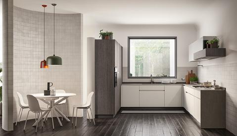 Modern kitchen with white cabinetry, dark flooring, a dining table with four chairs, and a large window providing natural light.