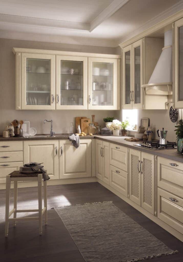Traditional kitchen with light wood cabinets, glass-front upper cabinets, and a dark wood floor.