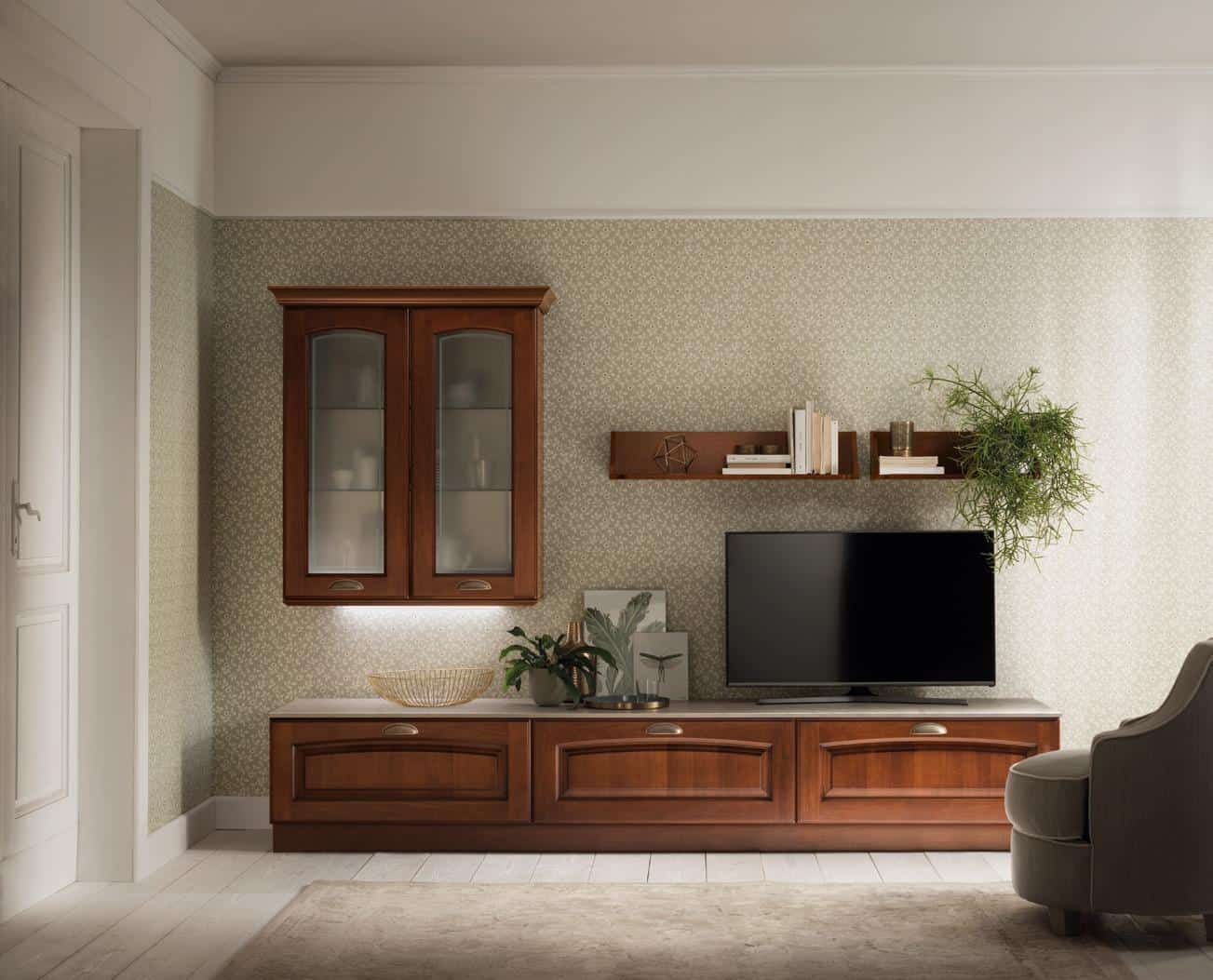 Living room with wooden furniture, including a wall cabinet, shelves with books and plants, a TV stand, and a TV.