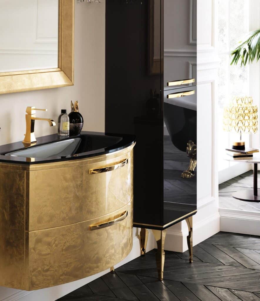 Luxury bathroom with a golden vanity, black countertop, and gold faucet, featuring elegant cabinetry and decorative items.