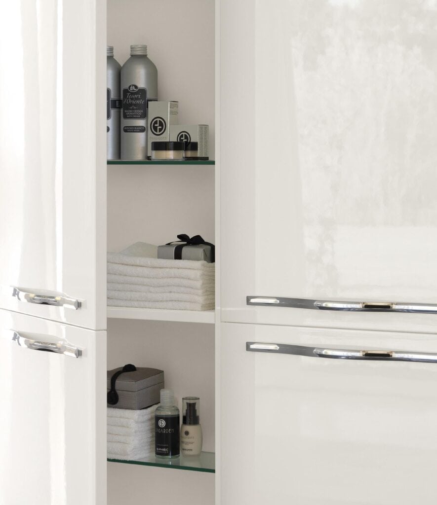 Bathroom cabinet with neatly arranged toiletries and folded towels.
