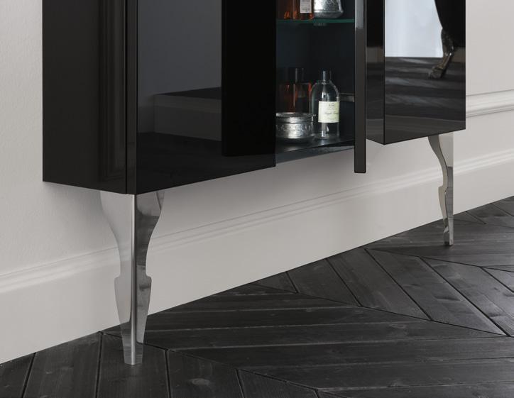 Black wall-mounted cabinet with reflective legs and dark herringbone wood floor.