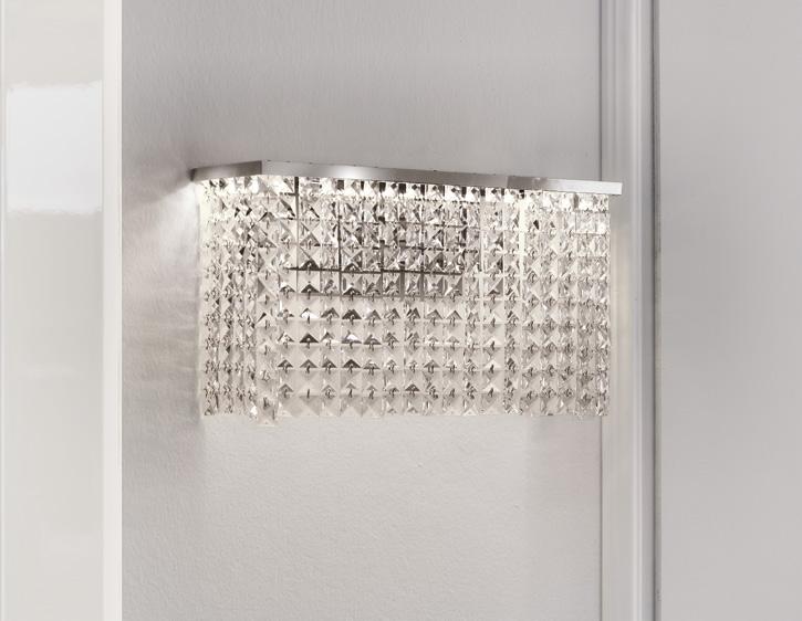 Crystal wall sconce with rectangular metallic base and cascading crystal prisms.