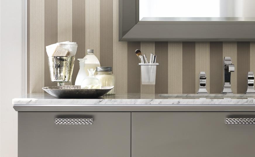 Elegant bathroom vanity with a marble countertop, chrome fixtures, and various toiletries arranged neatly, set against a striped wall background.