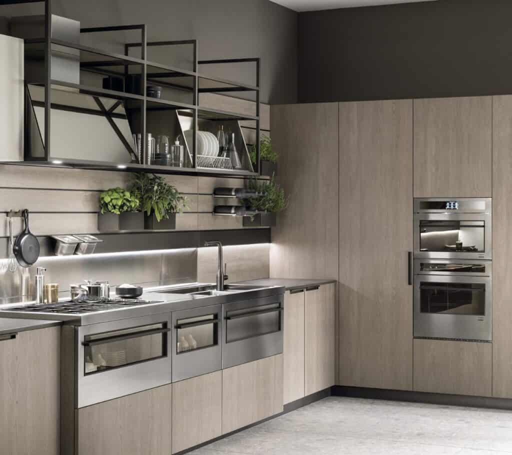 Modern kitchen with sleek cabinetry, stainless steel appliances, open shelving, and potted herbs on the wall.