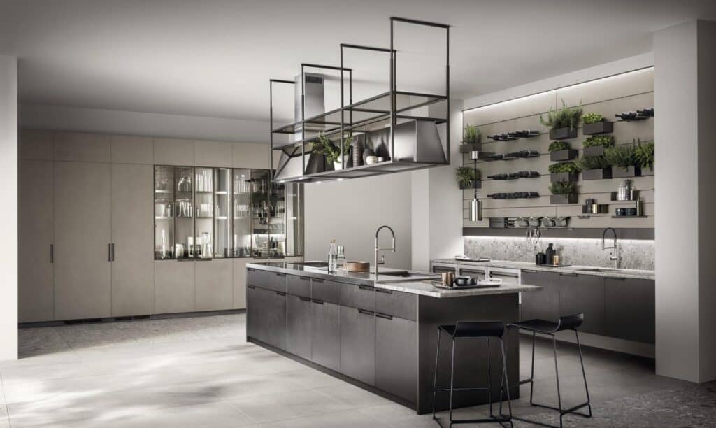 Modern kitchen with a central island, suspended shelving, and wall-mounted planters.