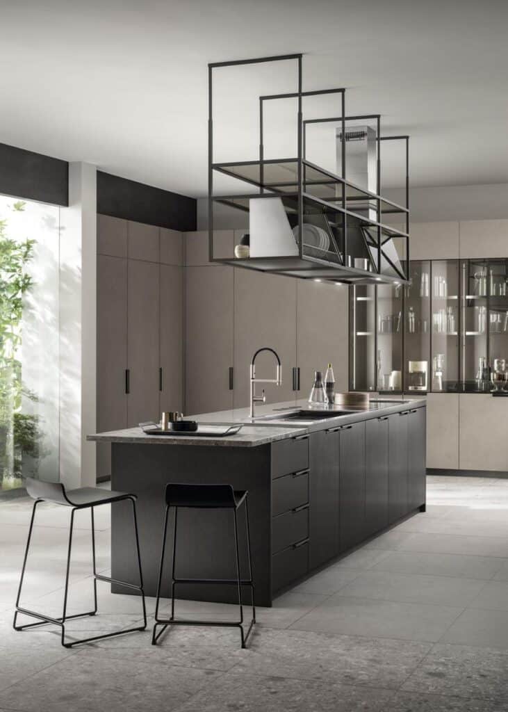 Modern kitchen with a sleek black island, two stools, and suspended shelving.