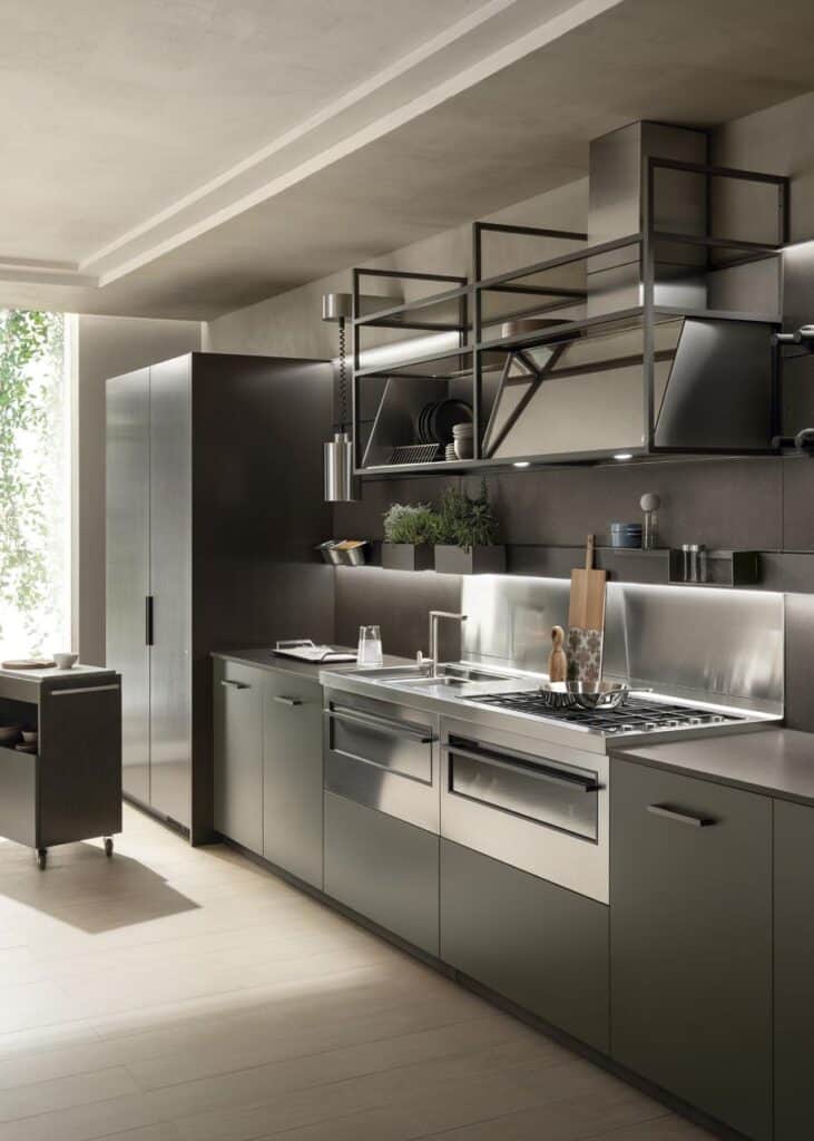Modern kitchen with stainless steel appliances, minimalist cabinetry, a sleek countertop, and open shelving above.