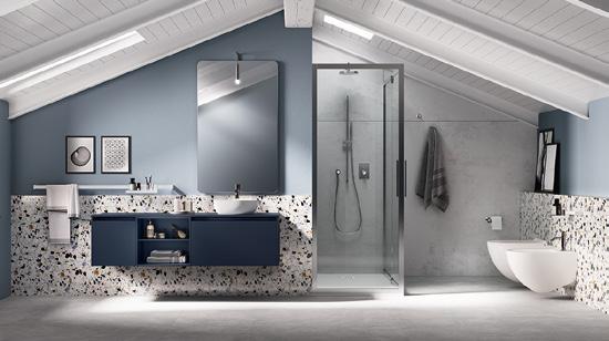 Spacious attic bathroom with blue walls, large mirror, dark blue vanity, open shower, and modern fixtures.