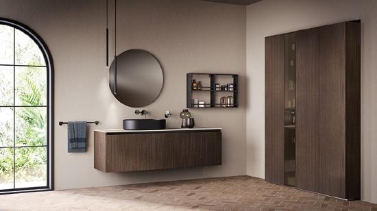 Modern bathroom with a large round mirror, dark wooden vanity, black basin, wall-mounted cabinet, and floor-to-ceiling window.