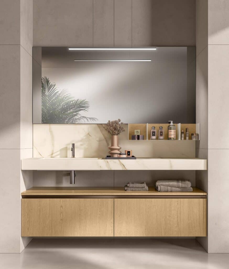 Modern bathroom vanity with a large mirror, marble countertop, wooden cabinet, and decorative toiletries.