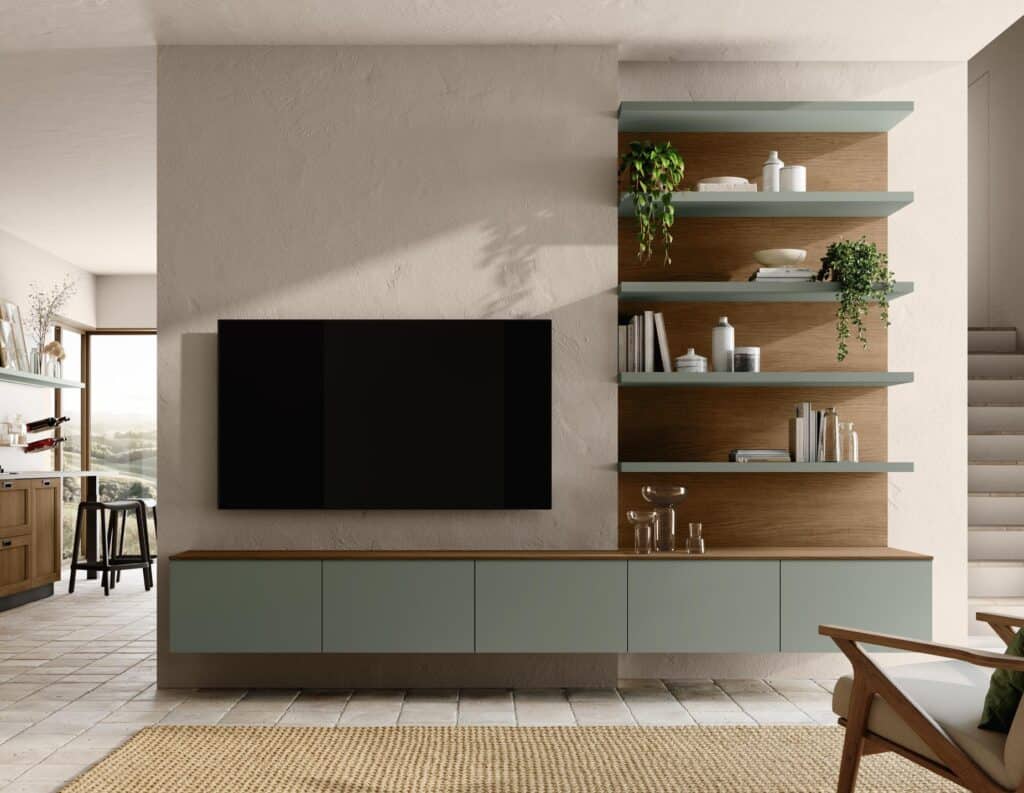 Modern living room with a mounted flat-screen TV, floating cabinets, and wall shelves decorated with plants and books.
