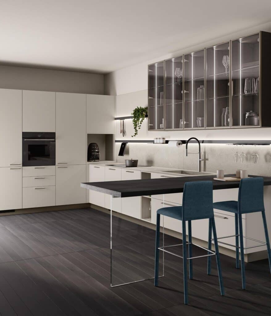 Modern kitchen with white cabinetry, dark floor, glass-front cabinets, and teal barstools at an extended counter.