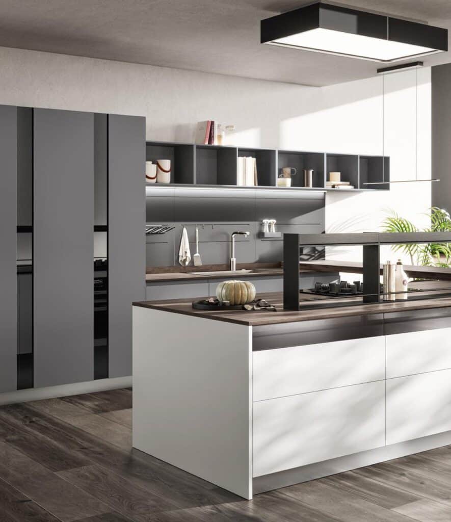 Modern kitchen with a sleek design featuring gray cabinets, wooden countertops, a central island with a stove, and open shelving, complemented by natural light and minimal decor.