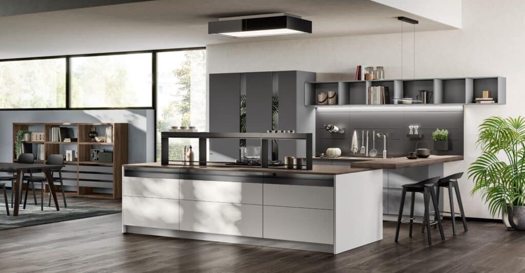 Modern kitchen interior with sleek cabinetry, a large island with a wooden countertop, minimalistic black chairs, and potted plant decor.