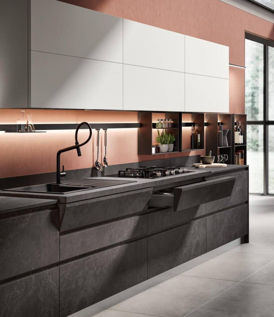 Modern kitchen with dark stone countertops, integrated stovetop, sleek cabinets, and minimalistic decor.