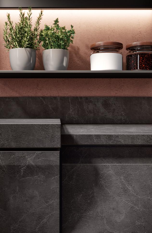 A kitchen shelf with potted herbs and jars, above dark stone cabinets.