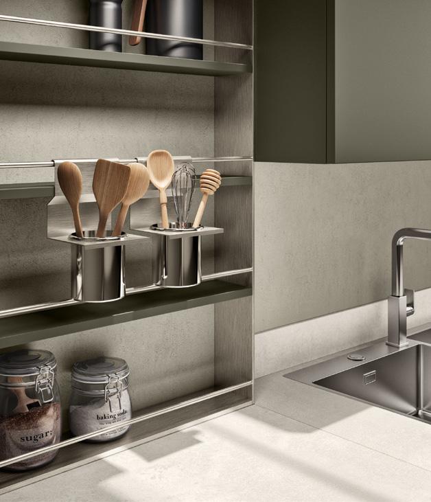 Modern kitchen countertop and shelving with metal containers holding wooden kitchen utensils, glass jars labeled &quot;sugar&quot; and &quot;baking soda,&quot; and a stainless steel sink.