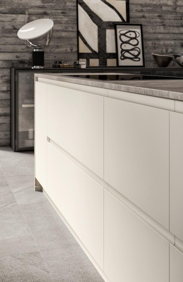 Modern kitchen interior with minimalist white cabinetry, concrete floor, and abstract wall art.
