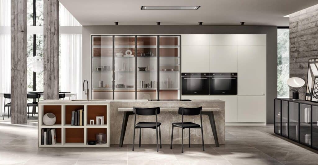 Modern kitchen with a large island, built-in ovens, glass cabinets, and minimalist decor.