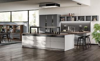 Modern kitchen with island, dark wood floors, and minimalist shelving.