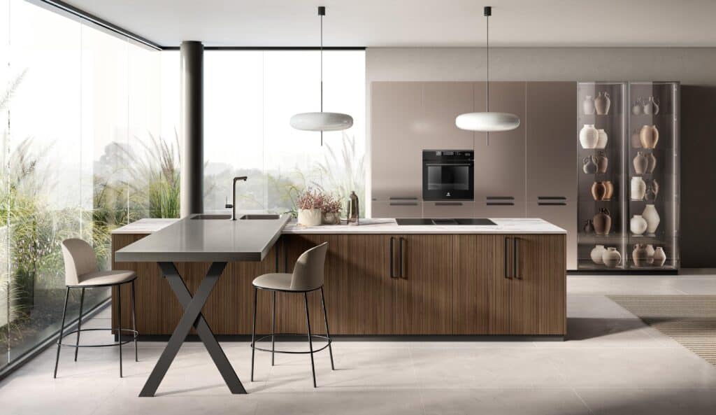 Modern kitchen with floor-to-ceiling windows, island with seating, built-in oven, and display cabinet with pottery.