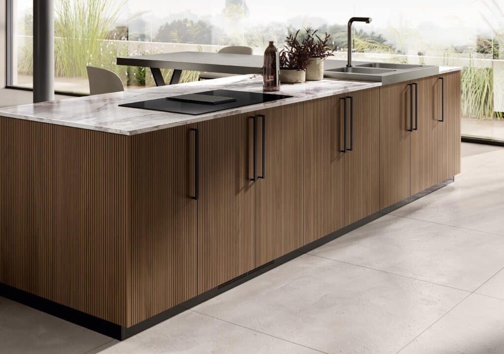 Modern kitchen island with a ribbed wood finish, featuring a marble countertop, a built-in stovetop, and a sink.
